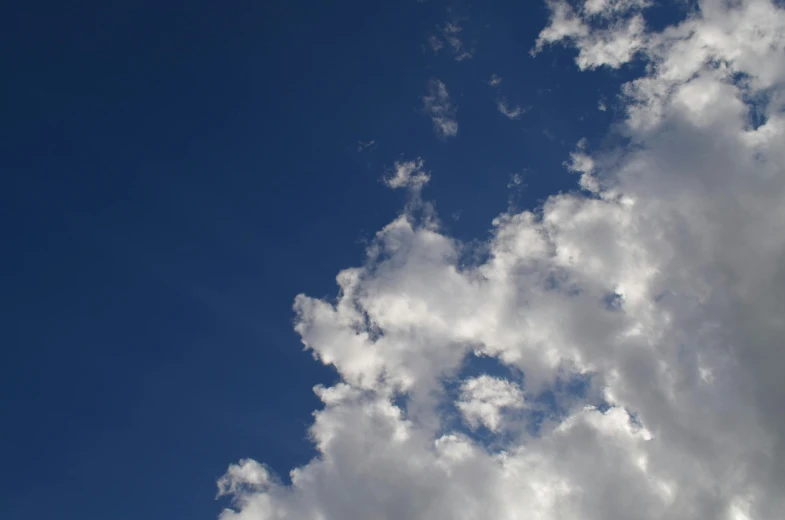 a plane flying through a cloudy blue sky, by Jan Rustem, unsplash, prismatic cumulus clouds, looking up to the sky, ignant, cloudless-crear-sky