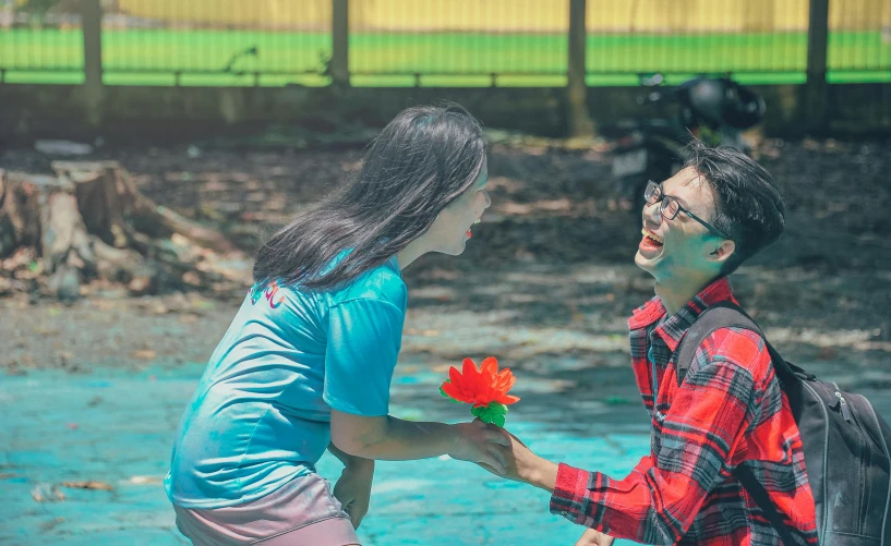 a man giving a flower to a woman, a colorized photo, pexels contest winner, hurufiyya, red and cyan ink, set on singaporean aesthetic, playful pose, 🌸 🌼 💮