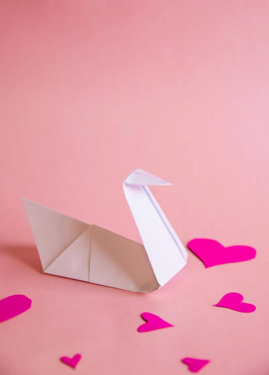 a paper swan on a pink background with hearts, by Julia Pishtar, trending on unsplash, square, programming, demur, folded