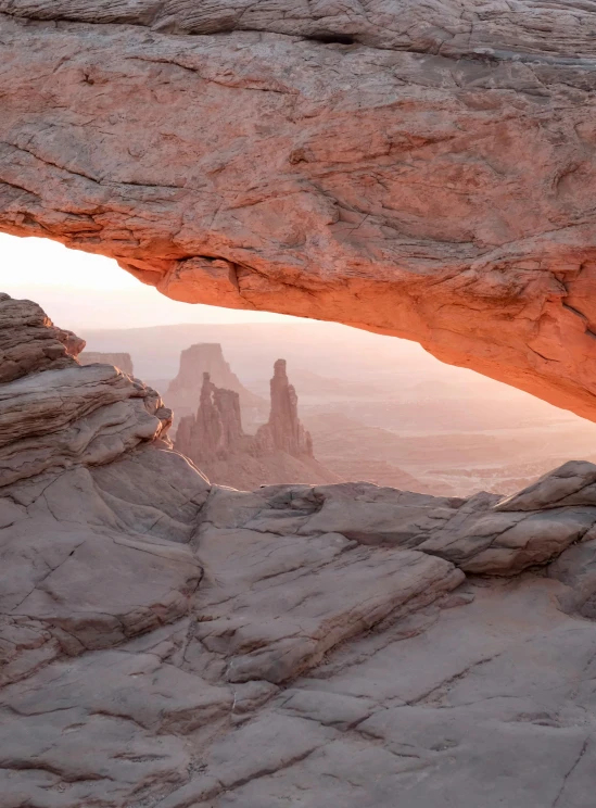 a large rock formation in the middle of a desert, unsplash contest winner, hudson river school, an archway, faded glow, 4k panoramic, archs