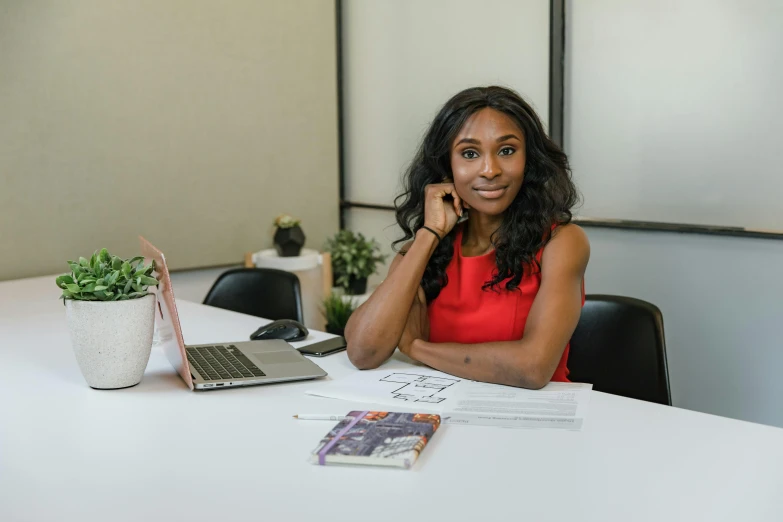 a woman sitting at a table with a laptop, mkbhd, professional profile picture, ashy, serena williams