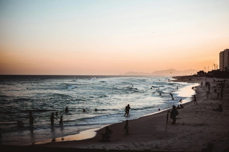 a group of people standing on top of a beach next to the ocean, pexels contest winner, renaissance, summer evening, soft-sanded coastlines, los angelos, people watching around