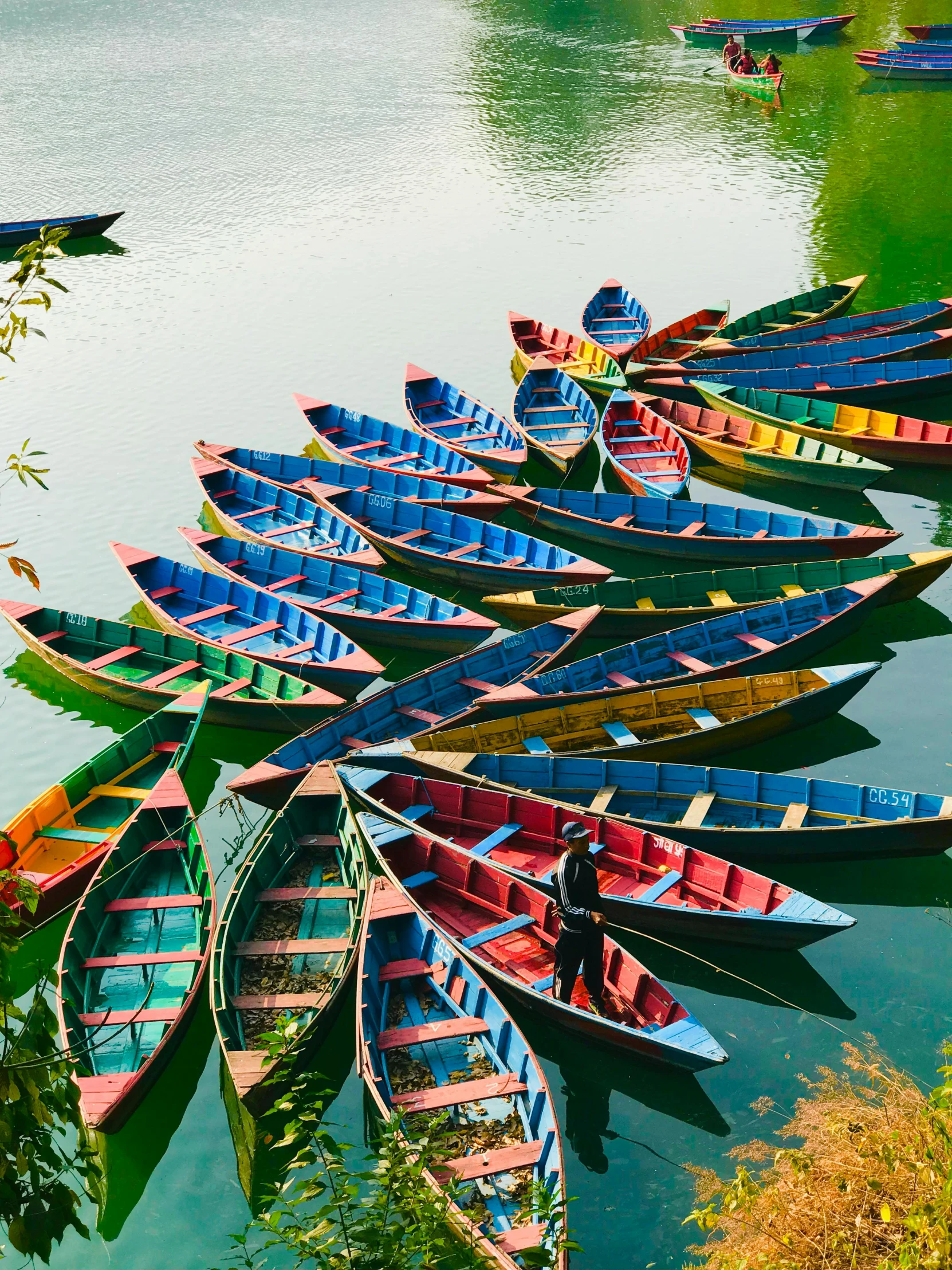 a number of small boats in a body of water, nepal, colorful photograph, 2019 trending photo, thumbnail