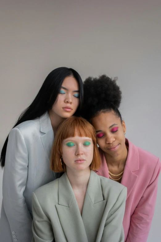 a group of three women standing next to each other, inspired by Russell Dongjun Lu, trending on pexels, pastel makeup, mixed race, piled around, futuristic