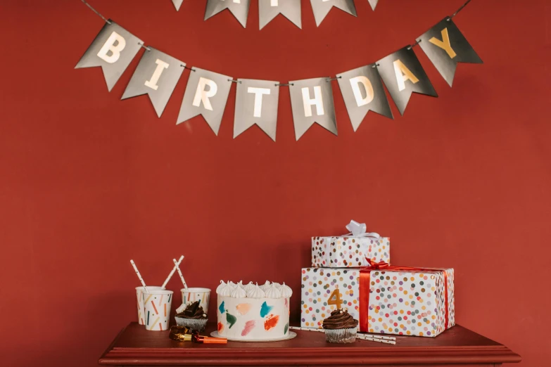 a birthday cake sitting on top of a table, by Julia Pishtar, graffiti, emma bridgewater and paperchase, gray, small, banners