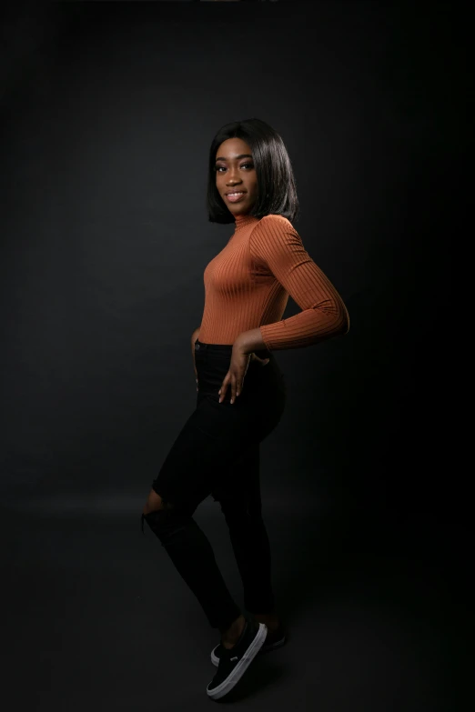 a woman standing in front of a black background, modeling shoot, riyahd cassiem, kezie demessance, plain background