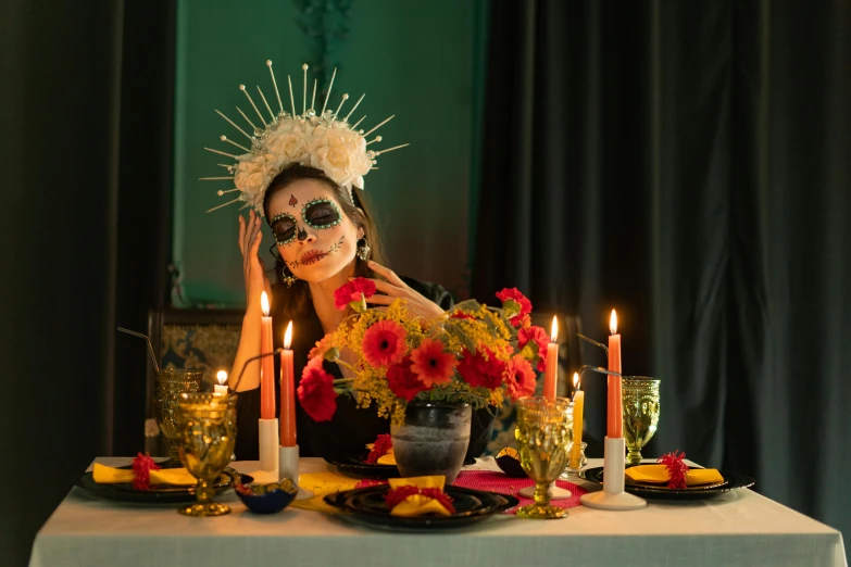 a woman in day of the dead makeup sitting at a table with candles, inspired by Kahlo, pexels contest winner, headpiece headpiece headpiece, square, fine dining, full-body