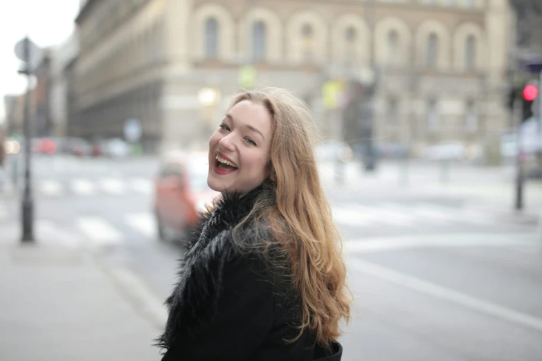 a woman standing on the side of a street, inspired by Louisa Matthíasdóttir, pexels contest winner, smiling laughing, young with long hair, helsinki, eleanor tomlinson