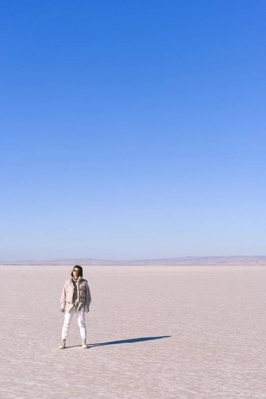 a person standing in the middle of a desert, clear blue skies, covered in salt, full body full height, on the runway