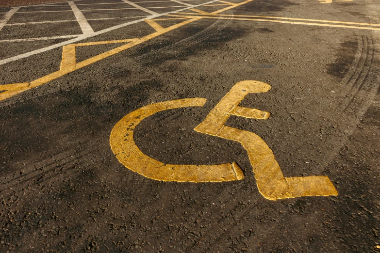 a parking lot with a handicap sign painted on it, shutterstock, auto-destructive art, square, lane brown, te pae, gold