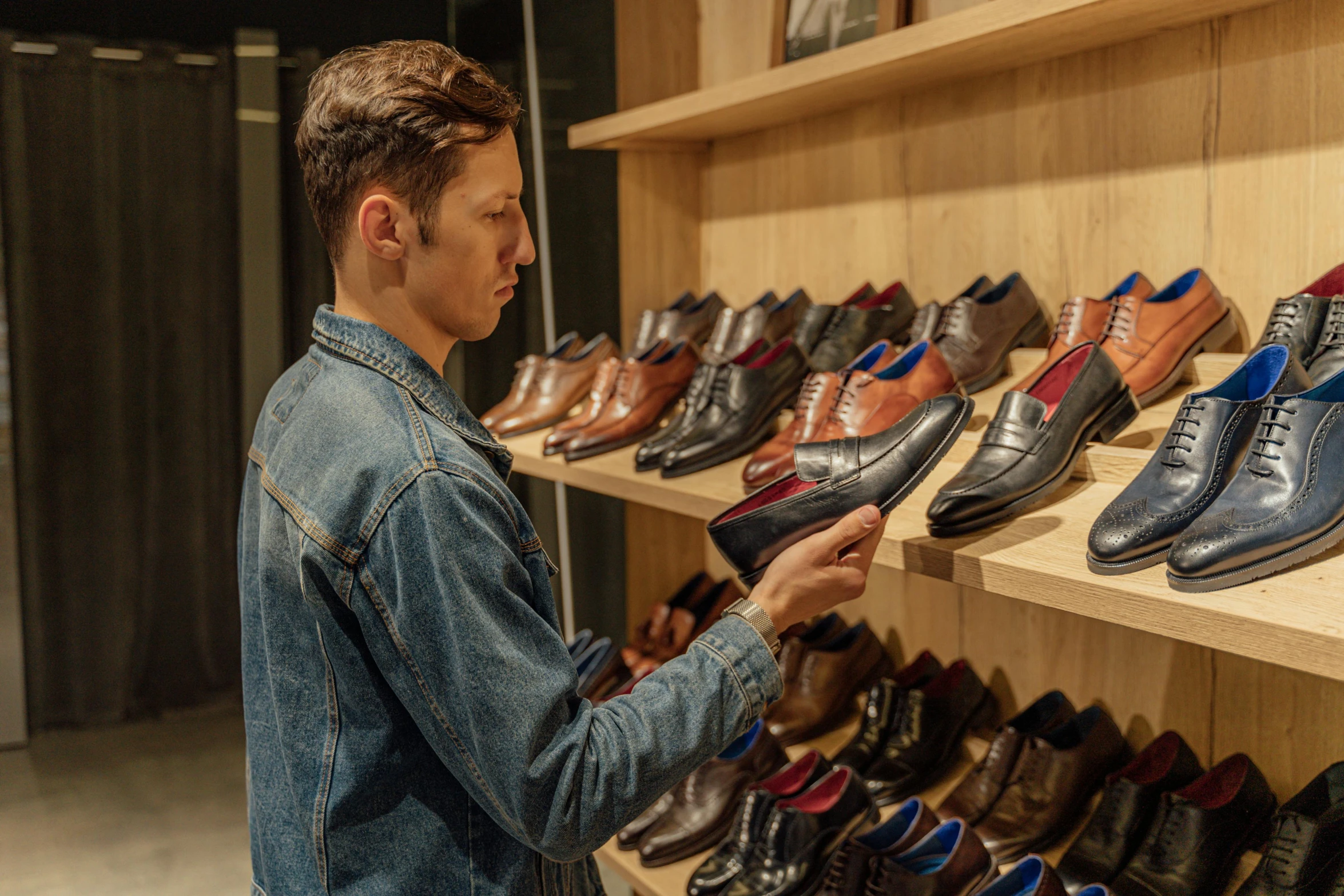 a man standing in front of a shelf of shoes, profile image, brown, sales, rectangle