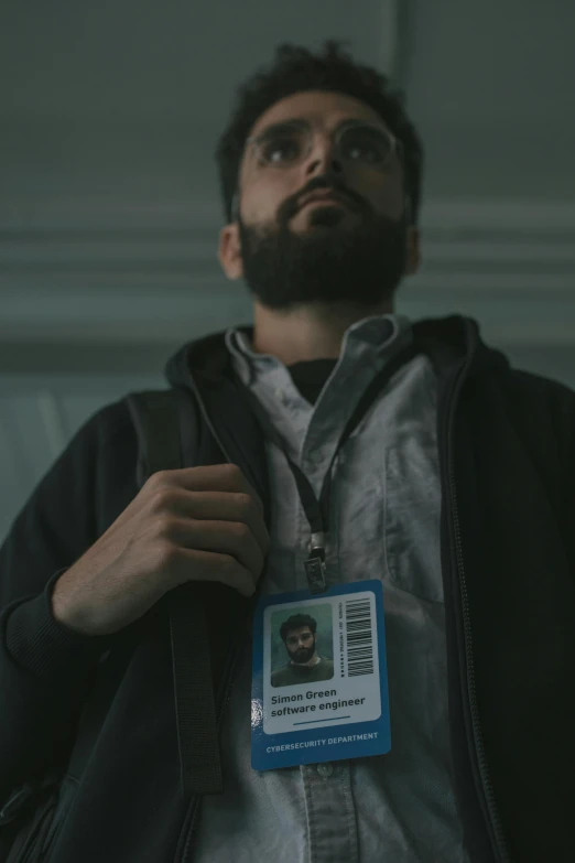 a man with a badge around his neck, pexels contest winner, a portrait of rahul kohli, shadowy informant, worksafe. cinematic, hacker