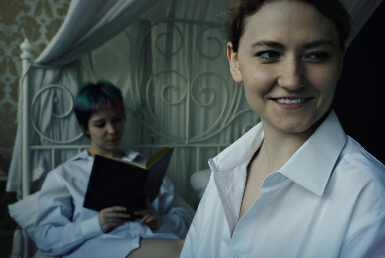 a woman sitting on a bed reading a book, a portrait, inspired by Nan Goldin, renaissance, wearing lab coat, worksafe. cinematic, two characters, welcoming grin