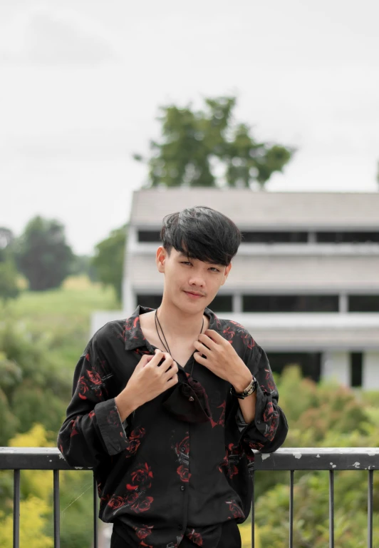 a man that is standing in front of a fence, inspired by Reuben Tam, unsplash, a handsome man，black short hair, malaysian, portrait androgynous girl, 2019 trending photo