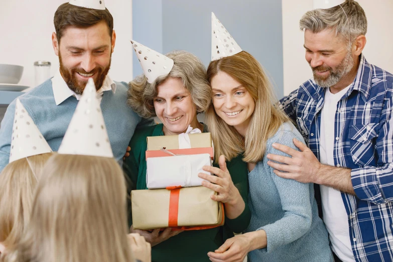 a group of people standing around a woman holding a present, pexels contest winner, happening, wearing a party hat, avatar image, middle age, cute photo