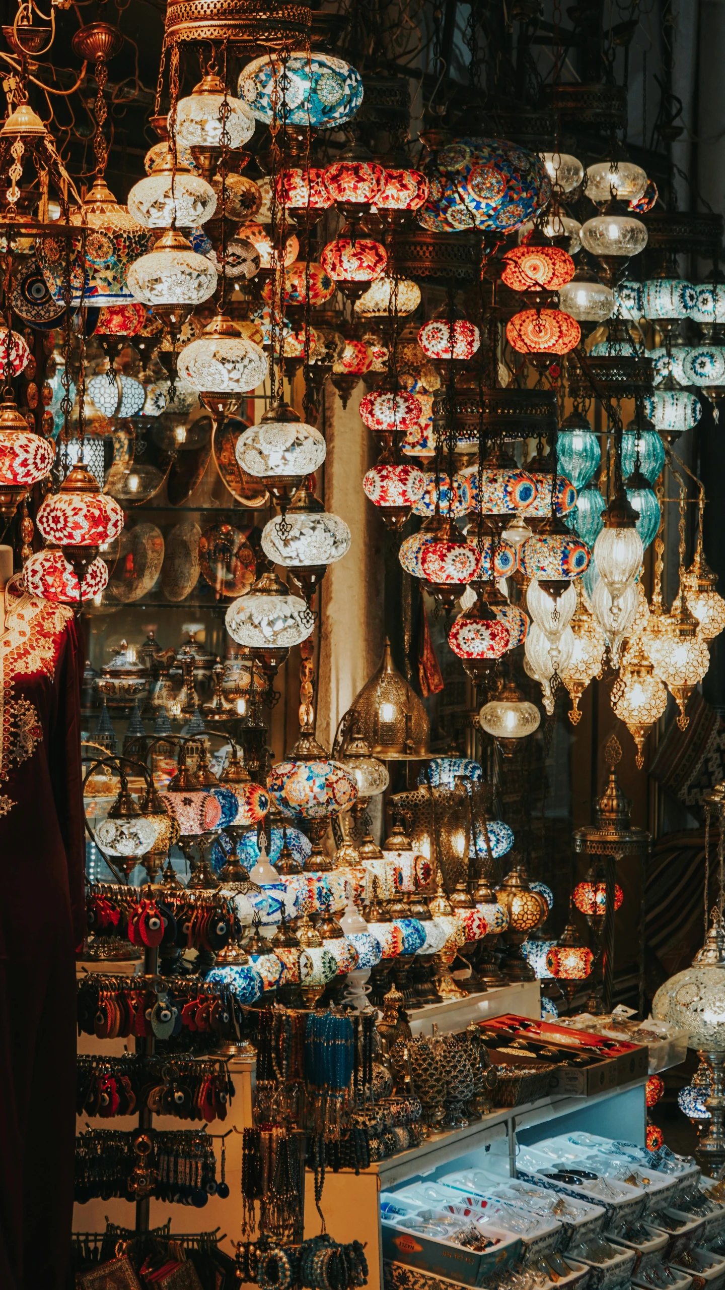 a store filled with lots of lamps hanging from the ceiling, by Matija Jama, trending on unsplash, orientalist, square, turquoise and venetian red, wide screenshot