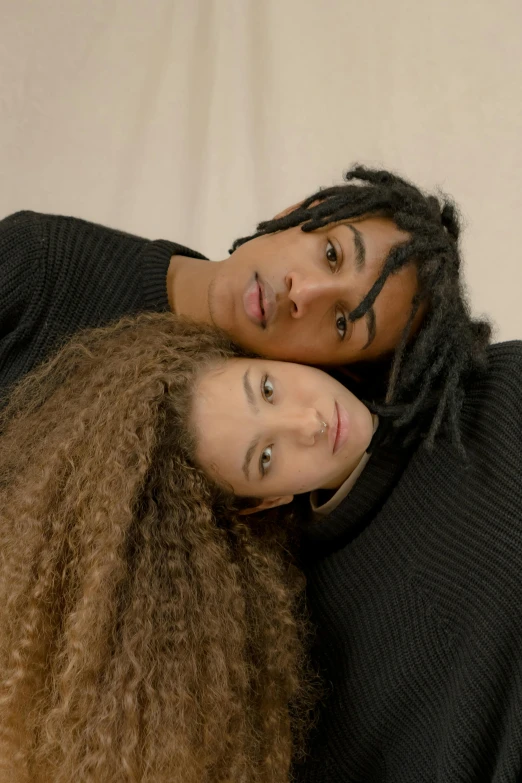 a couple of women laying on top of each other, by Cosmo Alexander, trending on pexels, renaissance, curls on top of his head, black teenage boy, wearing turtleneck, studio picture