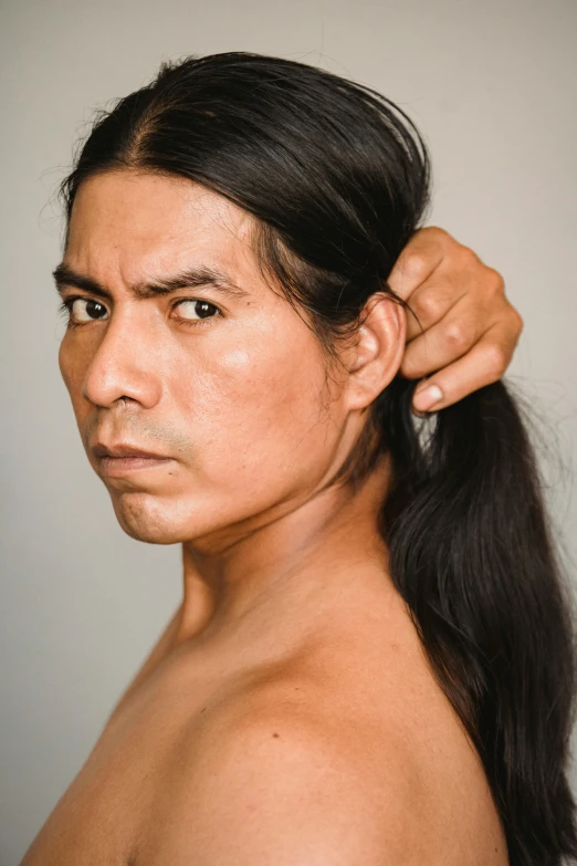 a woman brushing her hair in front of a mirror, an album cover, inspired by Jorge Jacinto, indigenous man, headshot photo, male model, wrinkles and muscles