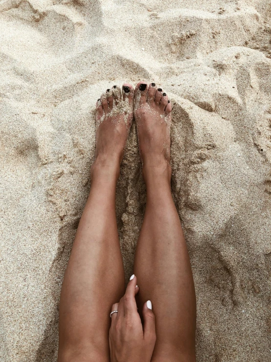 a woman's legs in the sand at the beach, trending on unsplash, renaissance, 💋 💄 👠 👗, slightly tanned, shiny skin”