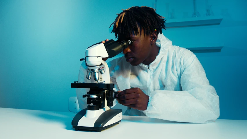 a man in a lab coat looking through a microscope, pexels contest winner, afrofuturism, black teenage boy, thumbnail, high quality image, avatar image