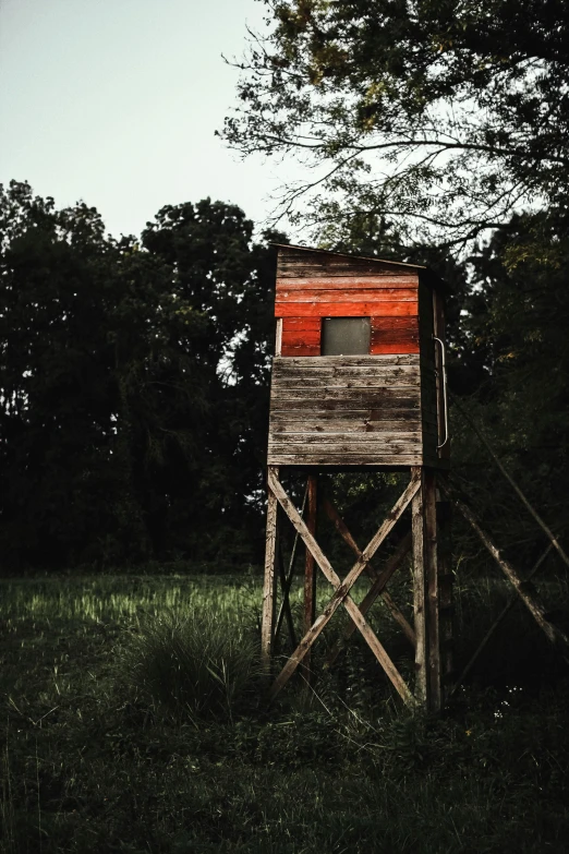 a wooden structure sitting in the middle of a field, hunting, instagram picture, crimson themed, high-resolution photo