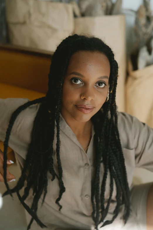 a woman with dreadlocks sitting on a bed, a portrait, by Winona Nelson, pexels, renaissance, olivia pope, still frame from a movie, big forehead, high quality photo