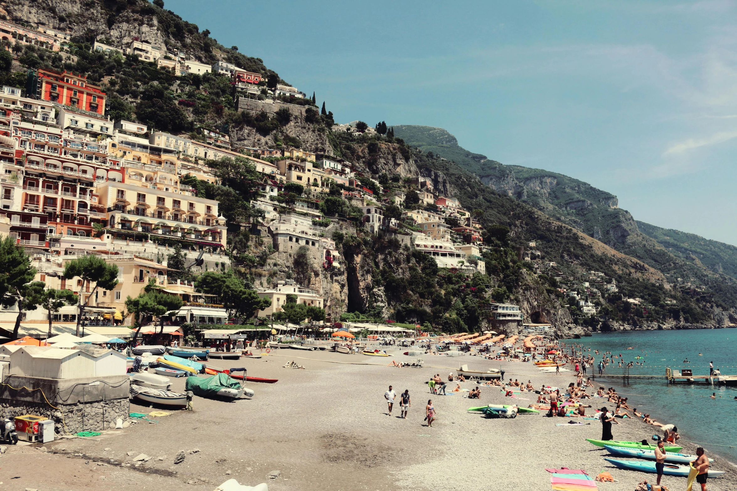 a beach filled with lots of people next to the ocean, by Anita Malfatti, pexels contest winner, renaissance, the village on the cliff, slim aarons, gondolas, a quaint