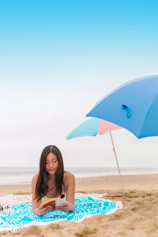a woman reading a book under an umbrella on the beach, a portrait, unsplash, conceptual art, santa monica beach, pastel blue, gongbi, uncropped