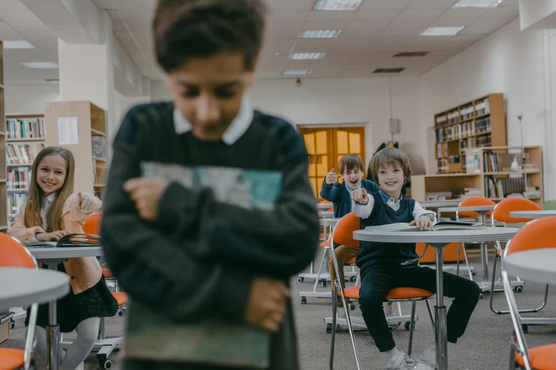 a group of children sitting at desks in a classroom, an album cover, by Anna Findlay, pexels contest winner, fighting stance, background image, lachlan bailey, 15081959 21121991 01012000 4k