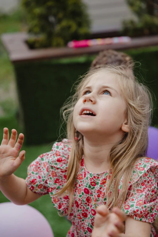 a little girl standing in front of a bunch of balloons, pexels, reaching towards the heavens, in the garden, small astronaut looking up, 4yr old