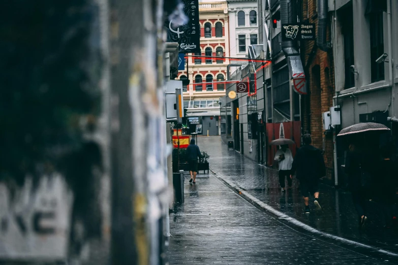 a person walking down a street with an umbrella, by Nick Fudge, pexels contest winner, street art, new zealand, narrow and winding cozy streets, knees tucked in | rain falls, in a city with a rich history