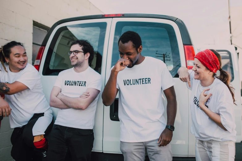 a group of people standing in front of a van, pexels contest winner, dressed in a white t shirt, compassionate, mkbhd, avatar image