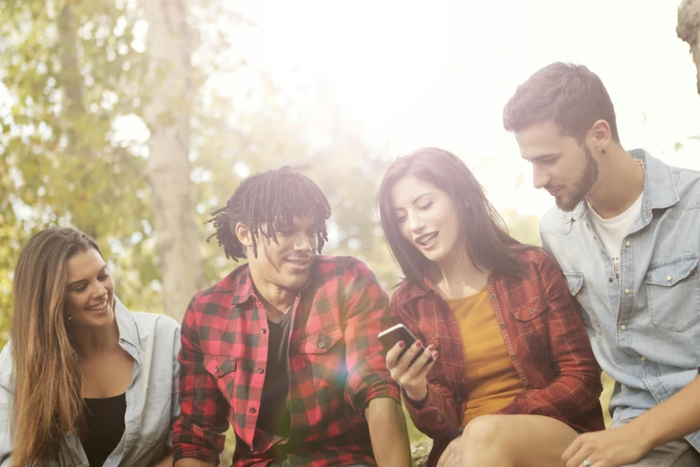 a group of young people sitting next to each other, a picture, shutterstock, happening, sydney park, looking at his phone, avatar image, te pae