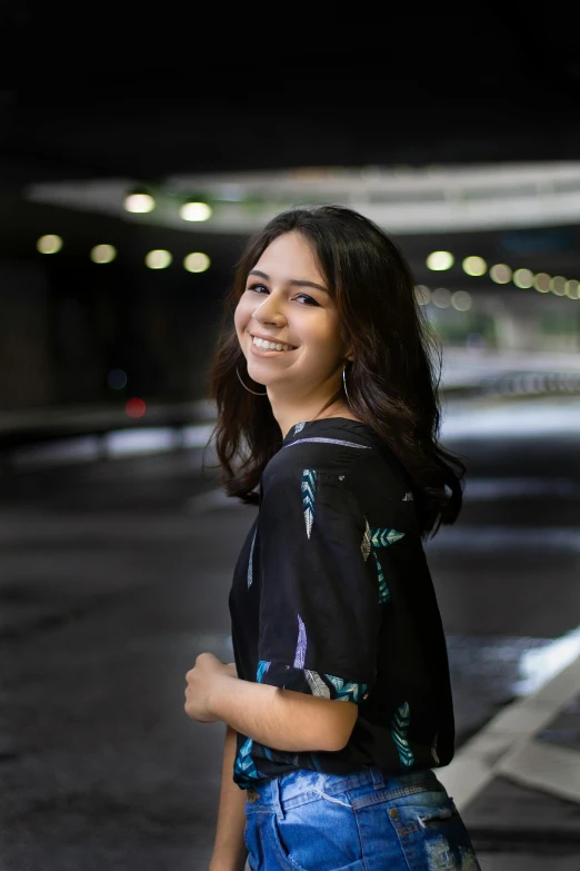 a beautiful young woman standing in a parking garage, by Alejandro Obregón, happening, while smiling for a photograph, post graduate, dark. no text, profile pic