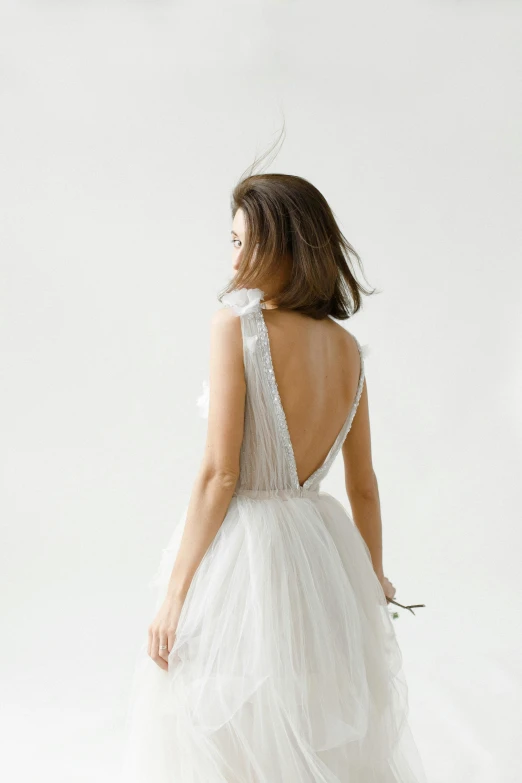 the back of a woman in a white wedding dress, inspired by Eva Gonzalès, reddit, white backdrop, curated collections, grey, sail