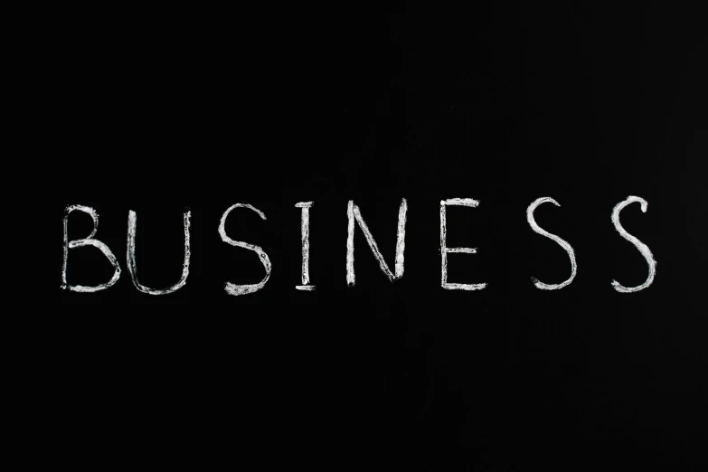 the word business written in white chalk on a blackboard, an album cover, pexels, [bioluminescense, business logo, 3 4 5 3 1, dressed