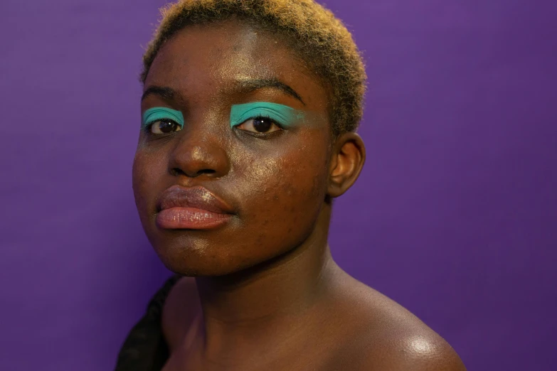 a close up of a person with makeup on, inspired by Elsa Bleda, trending on pexels, afrofuturism, gradient cyan to purple, ( brown skin ), full body image, black skin