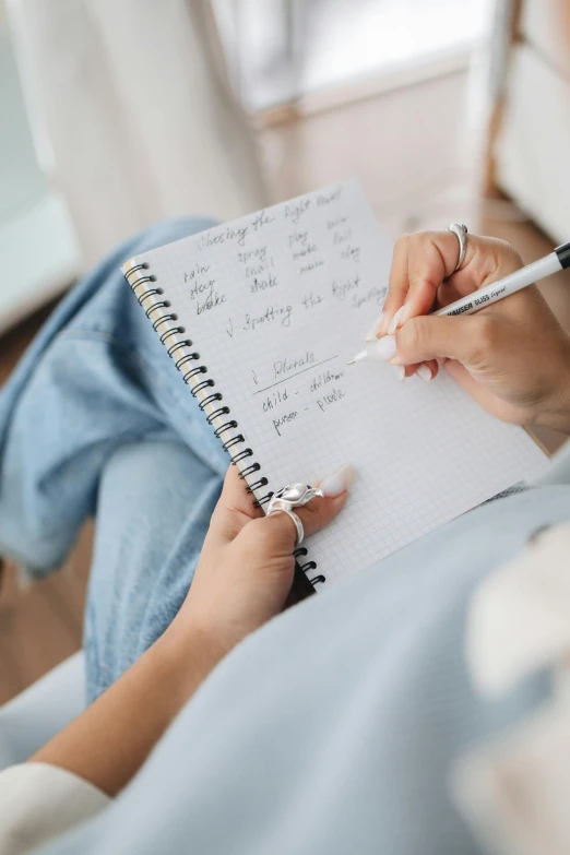 a woman holding a pen and writing in a notebook, by Nicolette Macnamara, day time, thumbnail, seasonal, centered shot