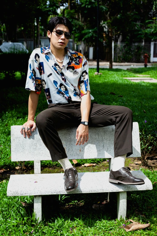 a man sitting on a bench in a park, an album cover, by Basuki Abdullah, hawaiian shirt, wearing military shoes, in style of thawan duchanee, off - white collection