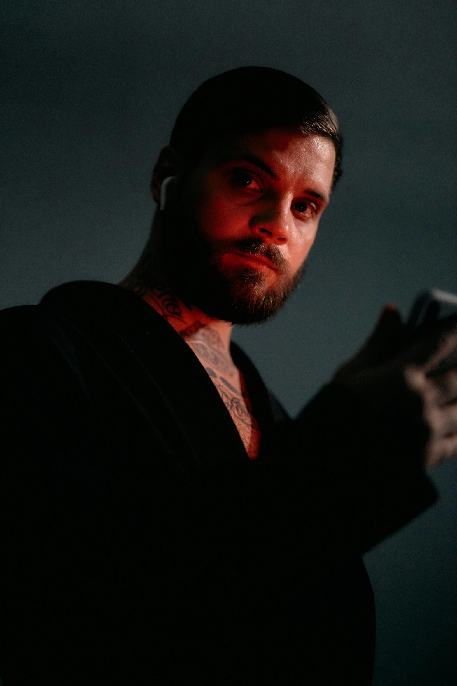 a man holding a remote control in his hand, a tattoo, by Adam Marczyński, pexels, renaissance, portrait of adam jensen, cinematic outfit photo, ( ( theatrical ) ), rugged man portrait