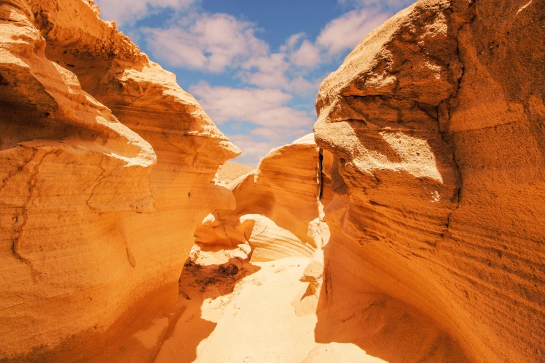 a narrow canyon in the middle of a desert, an album cover, pexels contest winner, australian beach, ancient ochre palette, devil's horns, youtube thumbnail