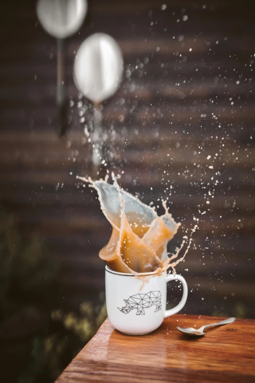 a cup of coffee with water splashing out of it, botanicals, caramel. rugged, promo image, high midair shot