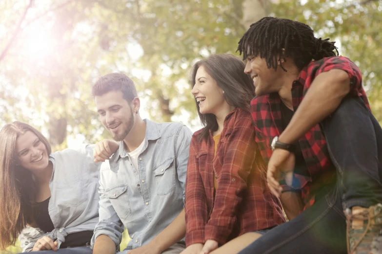 a group of young people sitting next to each other, a picture, shutterstock, essence, natural lighting, profile picture, smiling