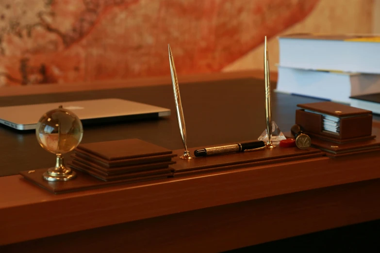 a laptop computer sitting on top of a wooden desk, inspired by Anna Füssli, glass and gold pipes, brown resin, fountain pen, bulgari