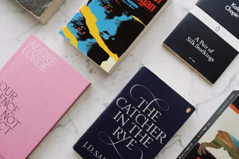 a bunch of books sitting on top of a table, by Helen Stevenson, trending on unsplash, analytical art, stanley kubrick movie, retro cover, joyce ballantyne style, detail shot