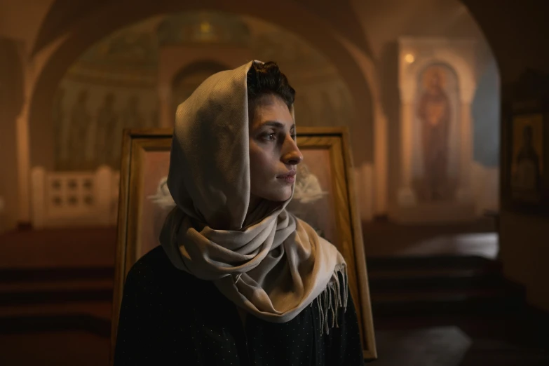 a woman wearing a headscarf in a church, a portrait, inspired by Andrei Rublev, pexels contest winner, medium format. soft light, middle eastern, brown, slav epic