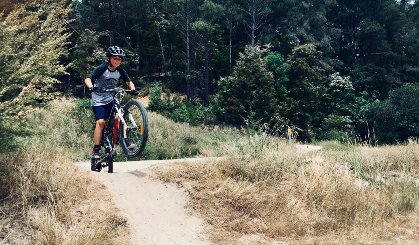 a man riding a bike down a dirt road, manuka, adventure playground, profile image, instagram photo