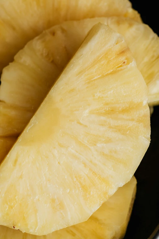 a close up of a sliced pineapple on a plate, by Jan Tengnagel, hurufiyya, with a black background, crisps, 4l, pine