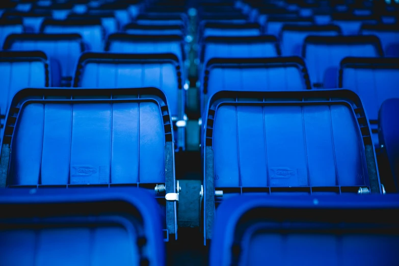 a row of blue seats sitting next to each other, profile image, sports photo, no text, complex scene
