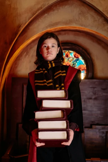 a woman is holding a stack of books, inspired by Hermione Hammond, renaissance, in an ancient vault, mackenzie foy, academic clothing, non-binary